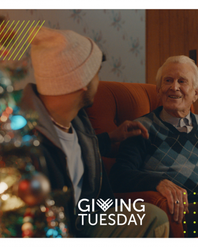 two men sitting on a couch talking